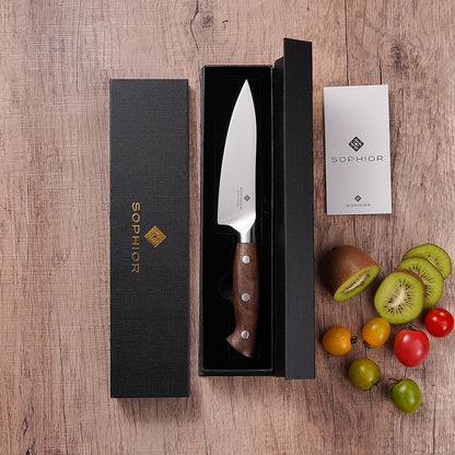 Koksmes 14 cm in geopende zwarte geschenkverpakking met kiwi en tomaten ernaast